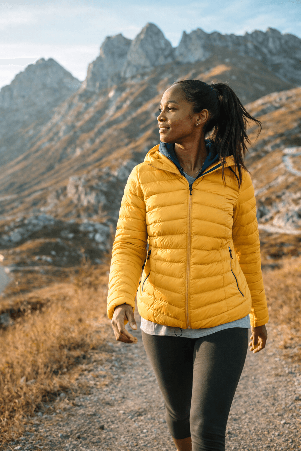 Woman hiking on a mountain trail.
