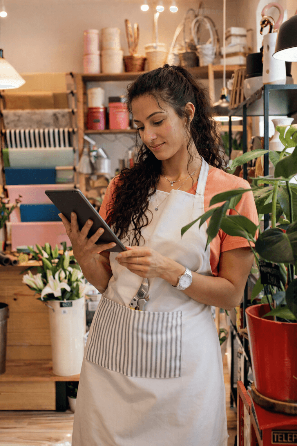 Small business owner using a tablet in her shop.